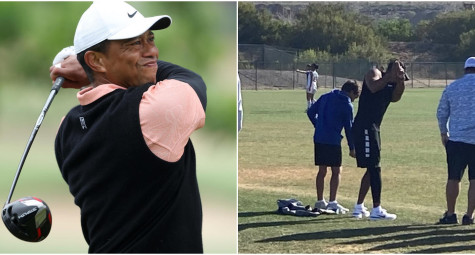 Tiger Woods tập swing trên sân bóng đá