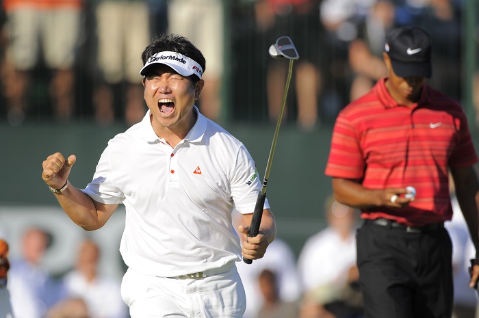 Y.E. Yang of Korea, left, celebrates after making a birdie putt on the 18th green to win the 2009 PGA Championship as Tiger Woods (USA), right, looks down at his ball at Hazeltine National Golf Club on Aug 16, 2009 in Chaska, MN. (AP Photo/Scott A. Miller)