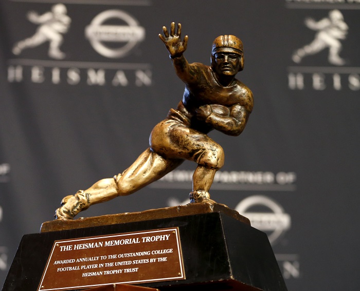 The Heisman Trophy is displayed prior to the announcement of the winner, Saturday, Dec. 13, 2014, in New York. The trophy will be awarded to one of the three finalists who are Wisconsin running back Melvin Gordon, Alabama receiver Amari Cooper and Oregon quarterback Marcus Mariota. (AP Photo/Julio Cortez)