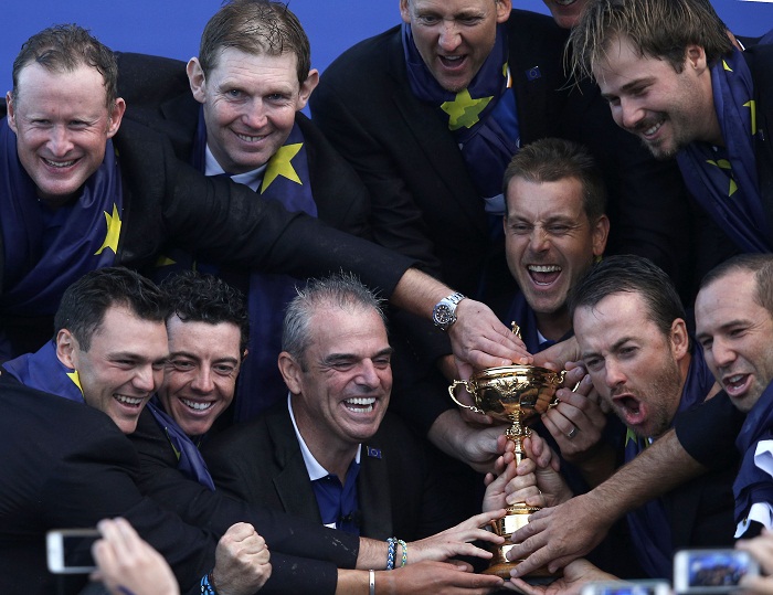 TOPSHOTS Players of Team Europe and their captain Paul Paul McGinley pose with the trophy as they celebrate on stage retaining the Ryder Cup on the final day of the Ryder Cup golf tournament at the Gleneagles Hotel in Gleneagles, Scotland, on September 28, 2014. Jamie Donaldson grabbed the crucial point Paul McGinley's side needed for the win when he defeated Keegan Bradley 4 and 3 in the 10th of the closing 12 singles. AFP PHOTO/ADRIAN DENNIS