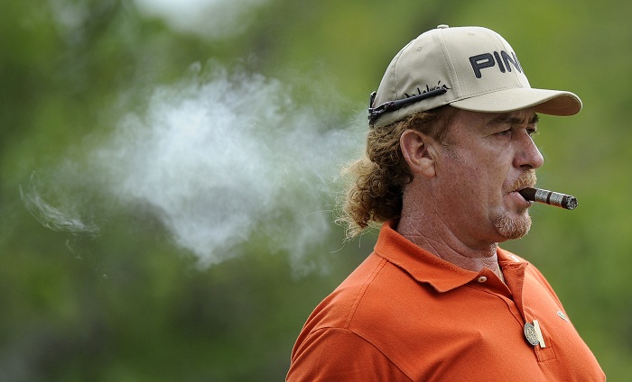 Miguel Angel Jimenez smokes a cigar during a practice round for the US Open Championship golf tournament in Bethesda, Md. Monday, June 13, 2011. (AP Photo/Nick Wass)