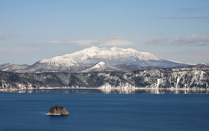 View of the mountains overlooking crater lake, Lake Mashu, Hokkaido, Japan.